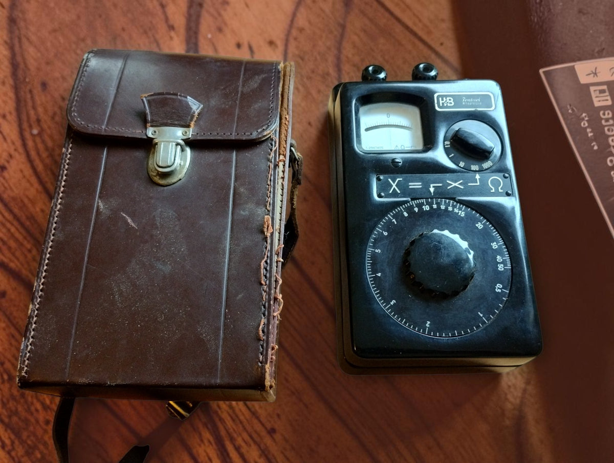 The Hartmann & Braun Pontavi Wheatstone bridge next to its vintage leather carrying case
