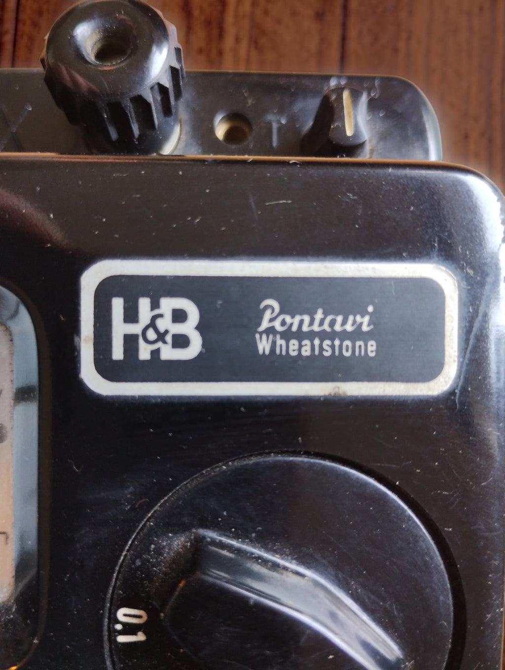 Close-up of the H&B Pontavi Wheatstone nameplate on the black bakelite front panel
