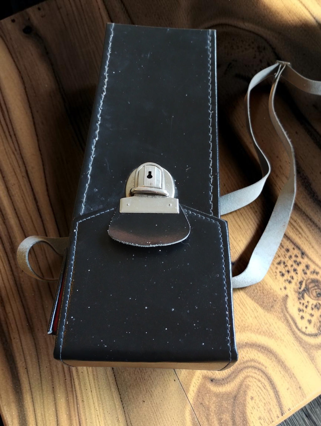 Closed black carrying case with metal clasp and shoulder strap for the Metra Blansko PK 210 clamp meter
