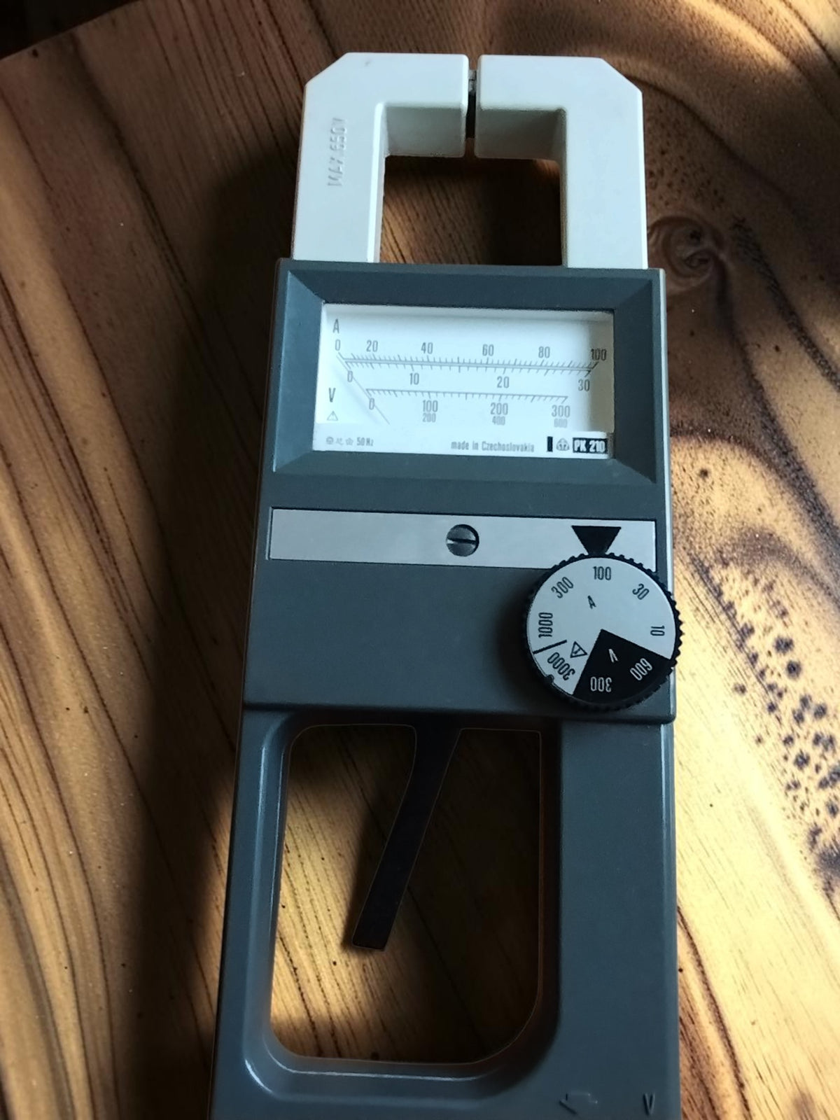 Front view of the Metra Blansko PK 210 analog clamp meter with measuring jaws and range selector
