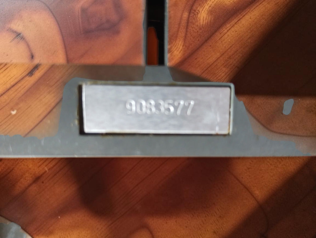 Rear detail of a vintage laboratory shunt showing stamped serial number 9033577 on a metal plate
