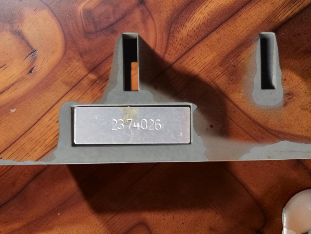 Rear detail of a vintage laboratory shunt showing stamped serial number 2374026 on a metal plate
