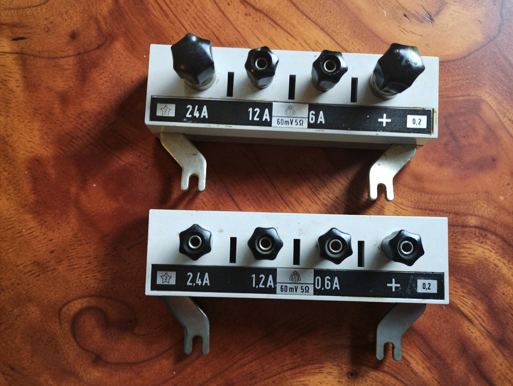 Pair of vintage laboratory shunts with white front panels, black binding posts and current ranges up to 2.4 A and 24 A
