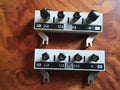 Pair of vintage laboratory shunts with white front panels, black binding posts and current ranges up to 2.4 A and 24 A
