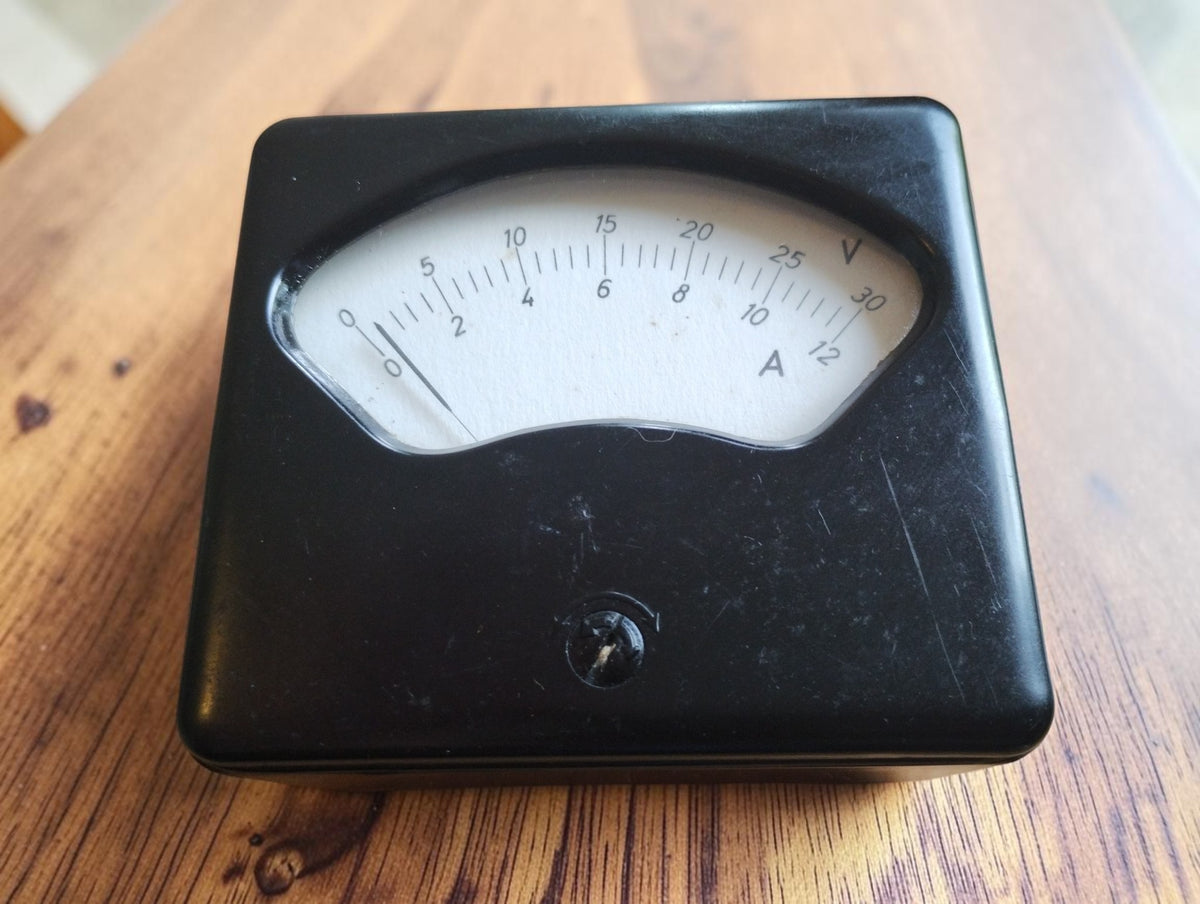 Front view of the black laboratory meter with dual scales marked 0–30 V and 0–12 A
