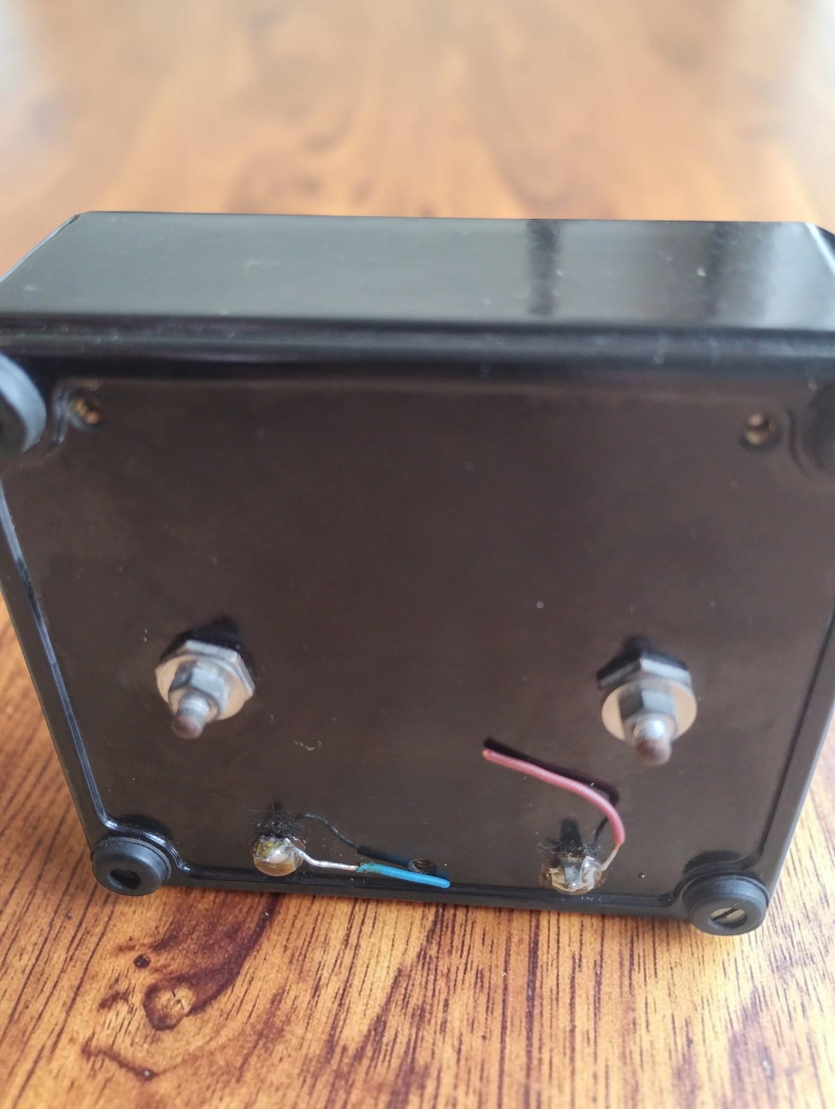 Rear view of the vintage laboratory meter showing connection terminals, mounting nuts and short wire remnants
