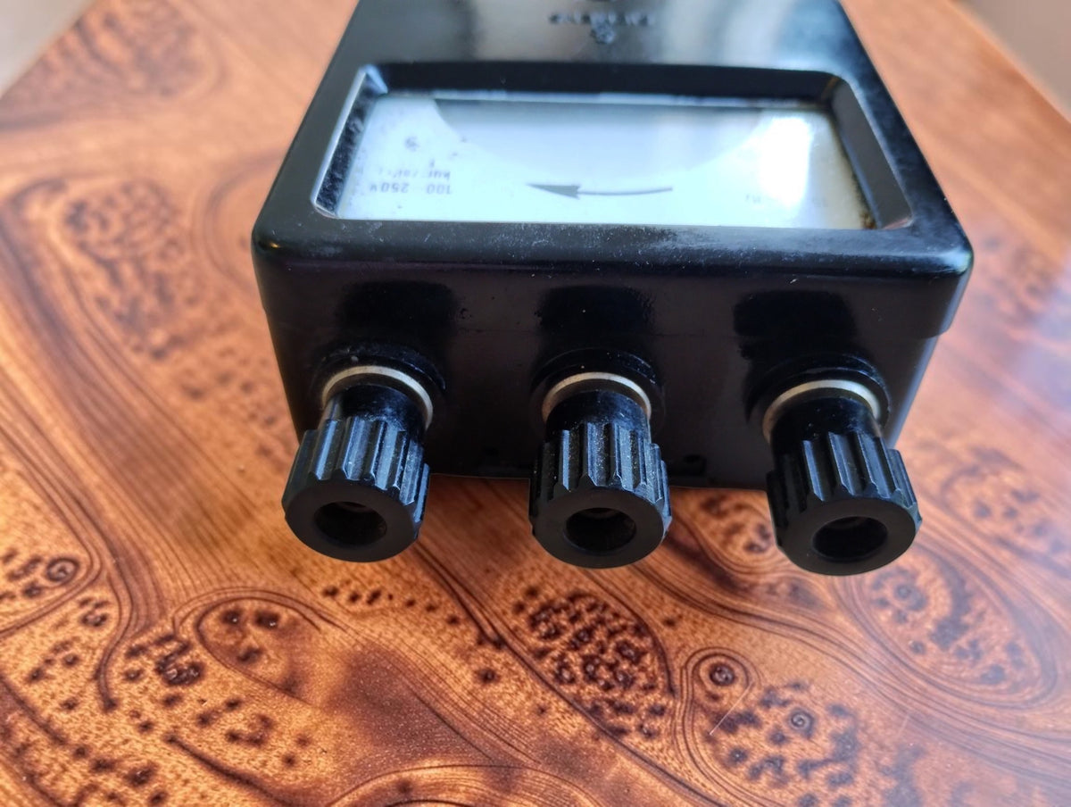 Angled view of vintage Siemens phase sequence indicator showing three black insulated connection terminals
