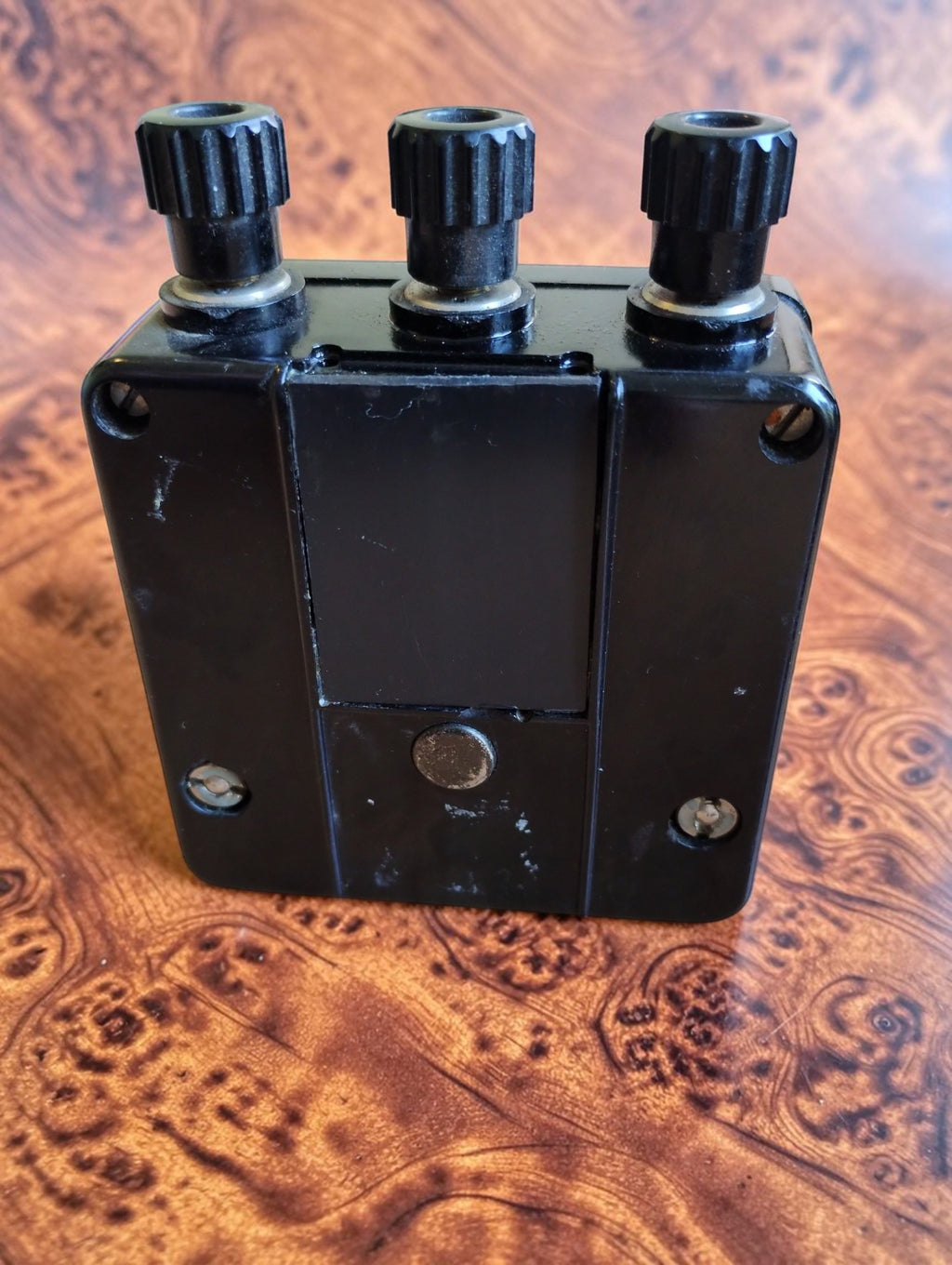 Rear view of vintage Siemens phase sequence indicator showing black housing, mounting screws and three terminals
