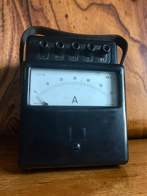 Vintage AEG analog ammeter with a black housing, broad 0–60 scale and multiple terminals along the top
