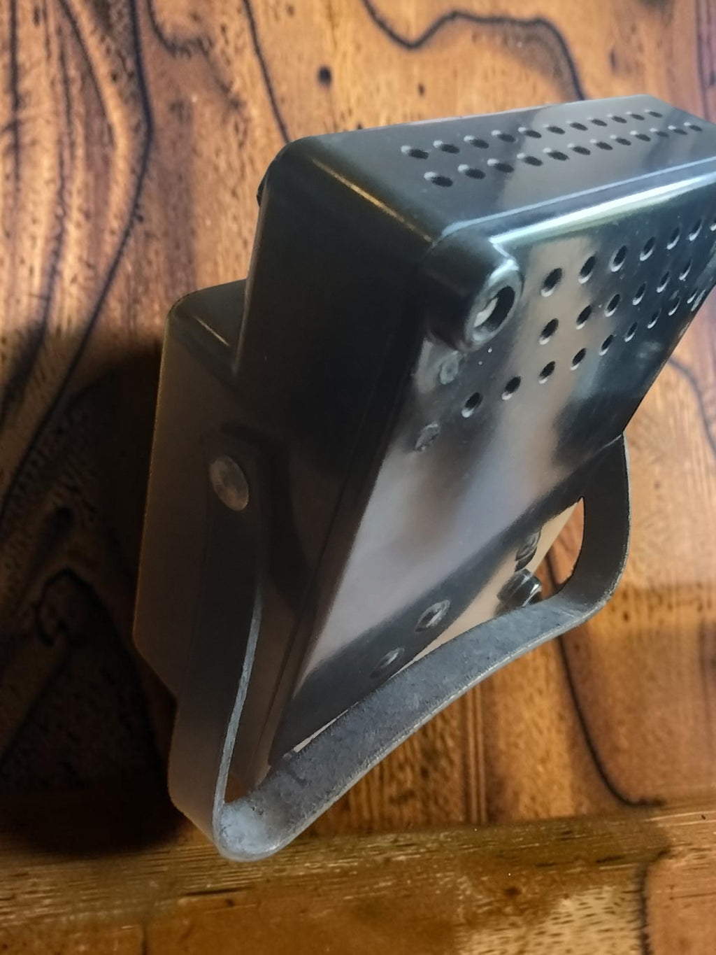 Rear view of the vintage AEG ammeter showing the perforated black housing and carrying strap
