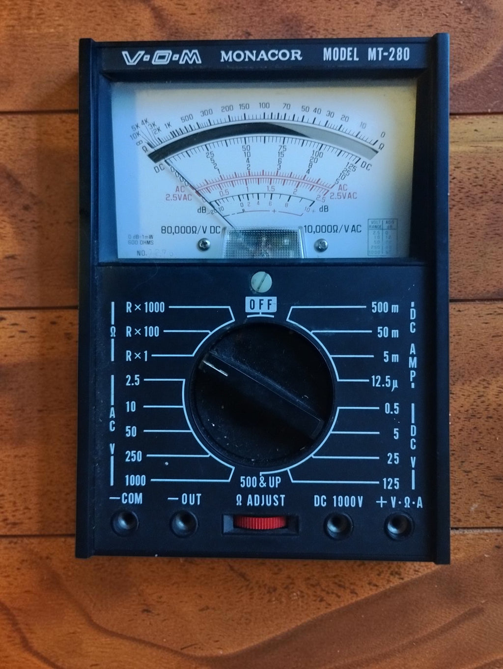 Front view of the Monacor MT-280 analog multimeter with its black case and analog dial
