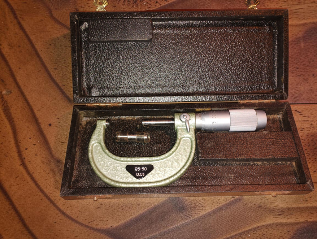 VIS 25–50 mm outside micrometer with setting standard in its open wooden storage box.
