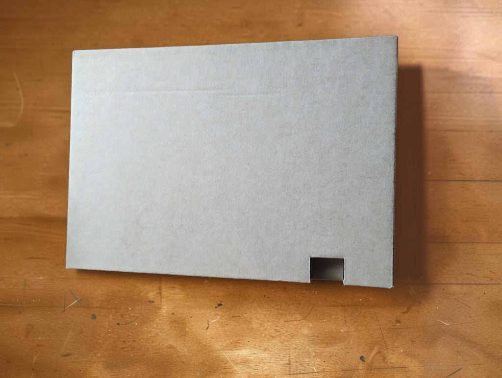 Cardboard inner packaging for the Casio CFX-9850GB PLUS-WE graphing calculator.
