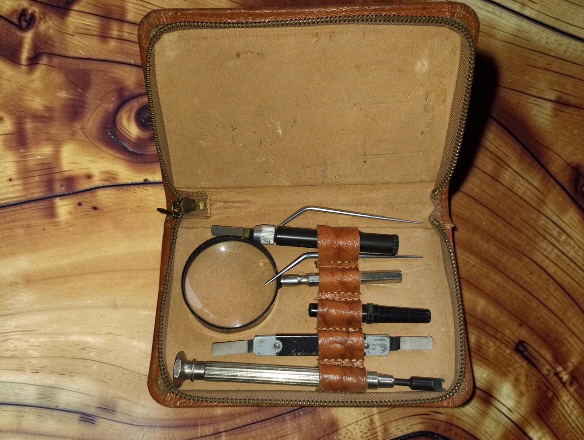 Vintage Siemens relay adjustment tool set in an open leather case with magnifying glass and precision tools
