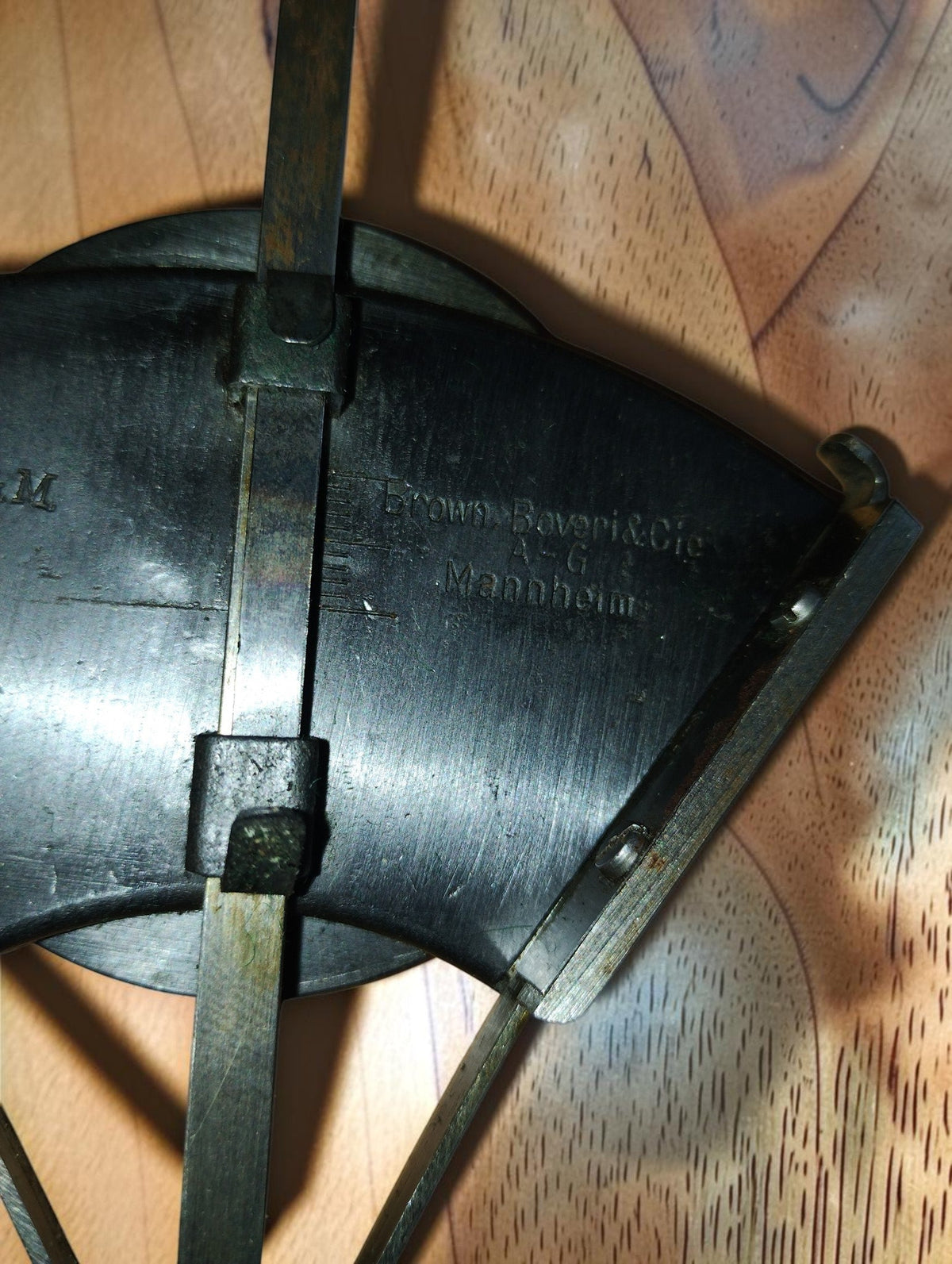 Close-up of the Brown, Boveri & Cie Mannheim maker's inscription, metal guides and scale markings.
