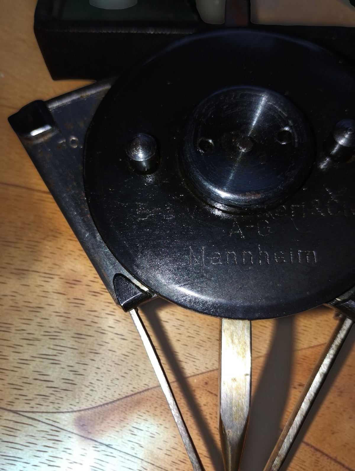 Rear view of the BBC mechanical calculating instrument showing the circular plate, raised fittings and Mannheim inscription.
