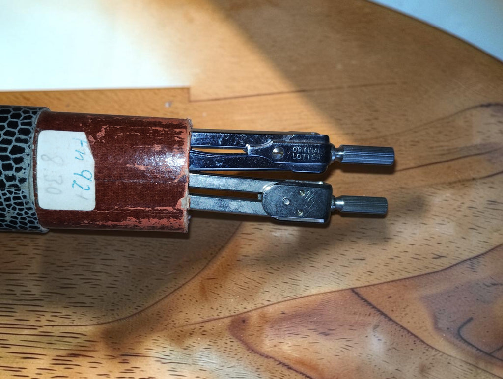 Two vintage drafting instruments partly exposed in their cardboard case, one marked ORIGINAL LOTTER
