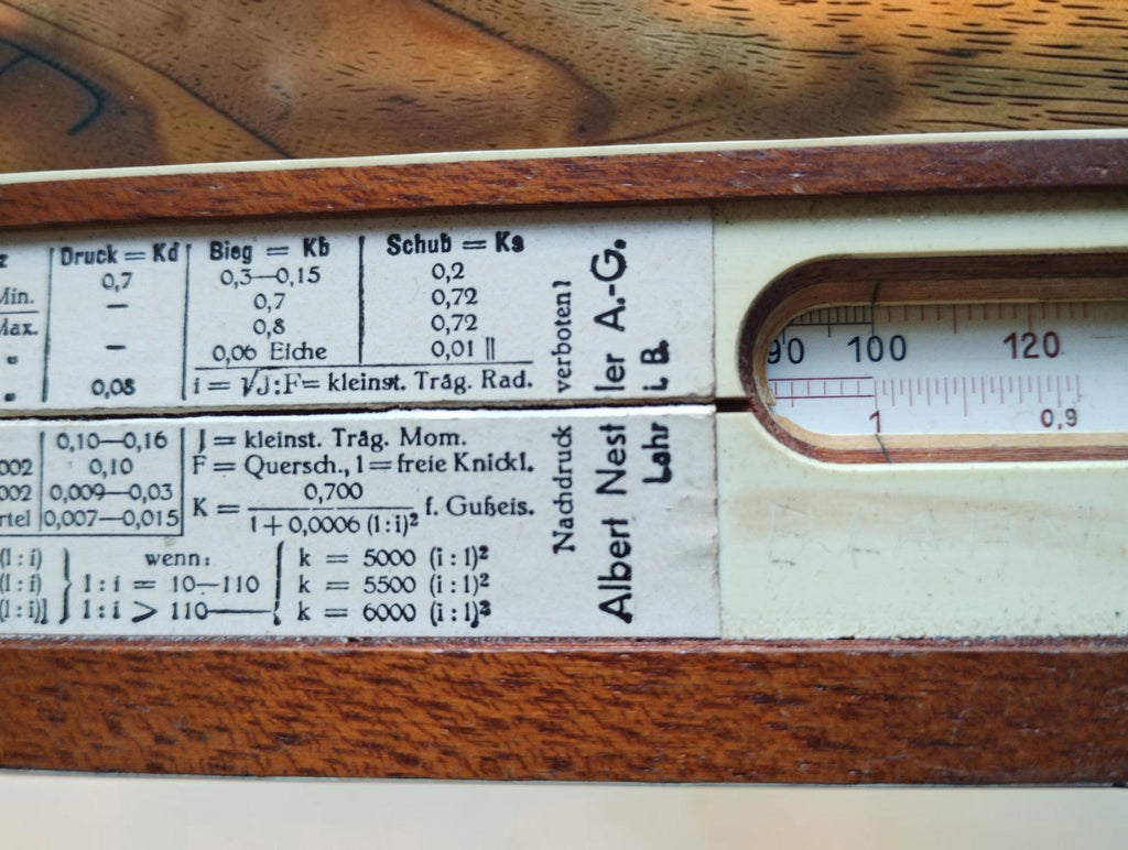 Close-up of reference tables and the rear scale window on an Albert Nestler wooden slide rule
