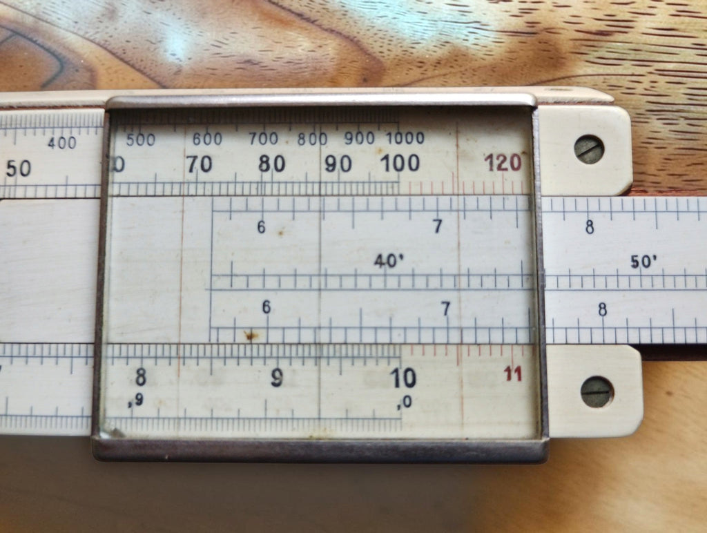 Close-up of the glass cursor and numbered scales on an Albert Nestler System Rietz slide rule
