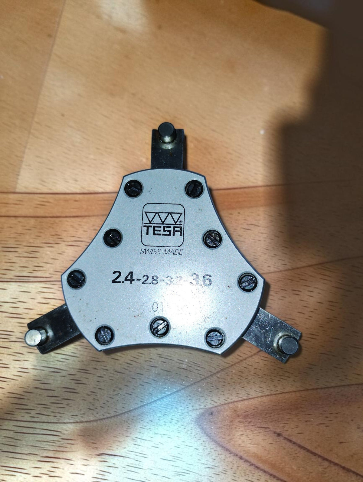 Underside of the TESA three-point measuring head, showing the Swiss Made logo, size markings and three measuring contacts.
