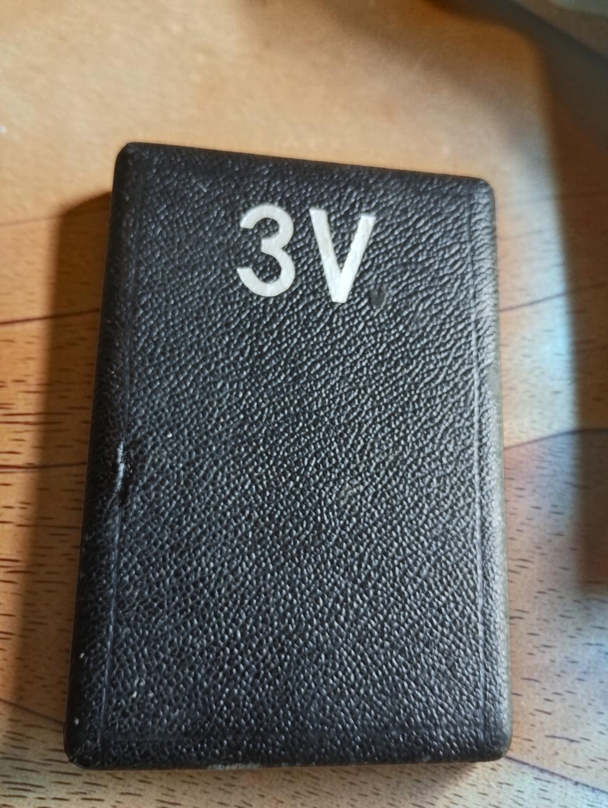 Closed black storage case for Metrawatt TEL-38 pocket voltmeter with 3V marking on the lid
