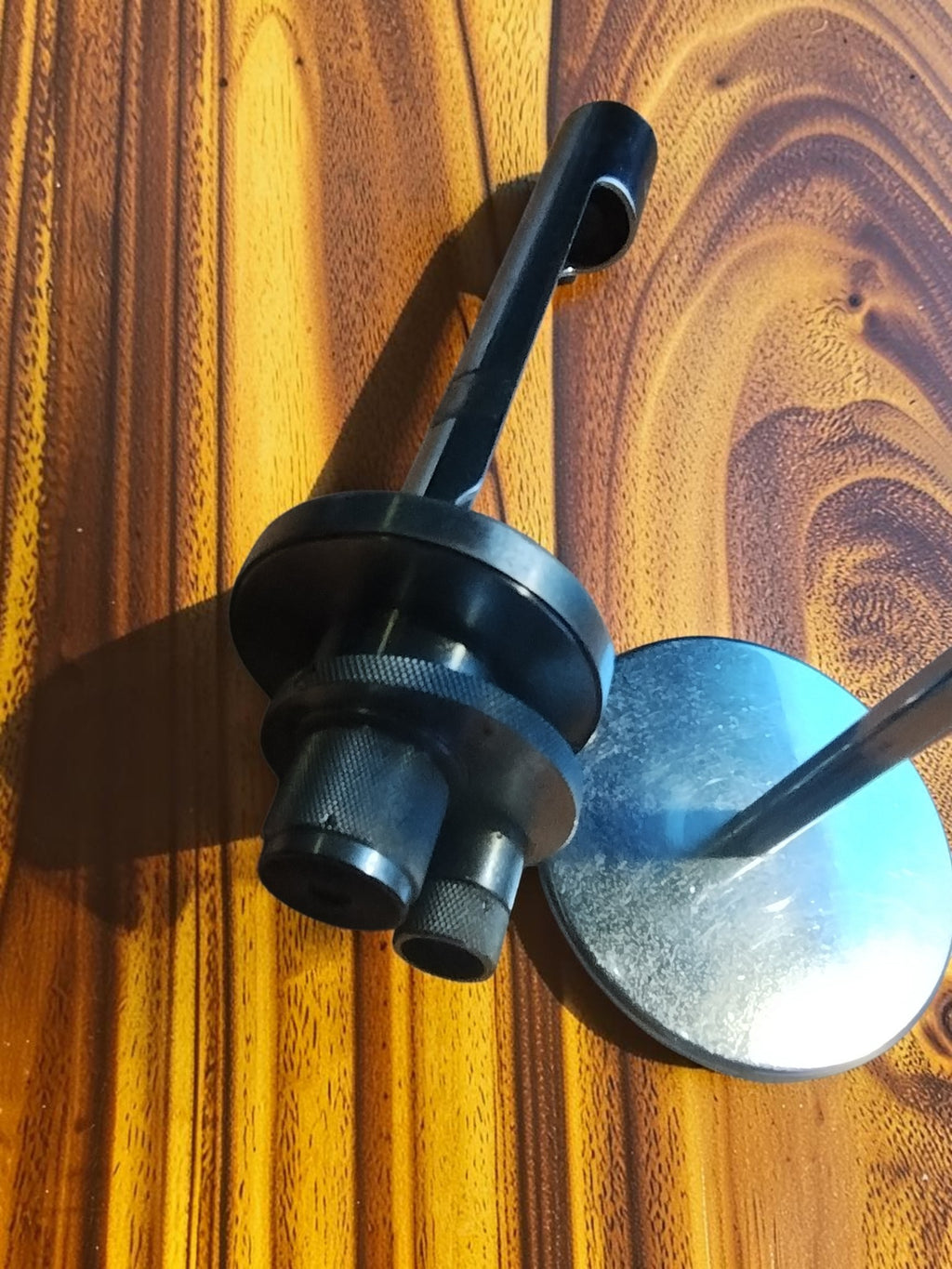 Angled view of the Carl Zeiss Jena vertical illuminator showing knurled adjustment rings, side port and round mirror
