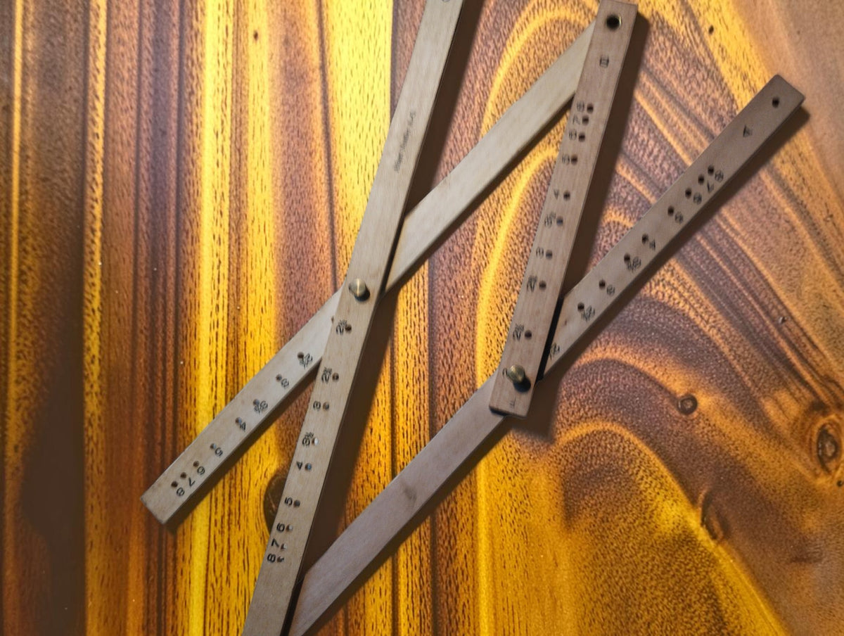 Albert Nestler No. 248 wooden pantograph unfolded, showing its jointed arms and numbered adjustment holes.
