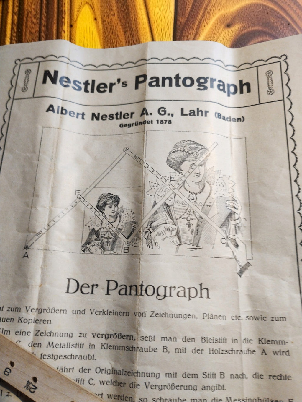 Original Nestler pantograph instruction leaflet with German text and an illustration of drawing enlargement.
