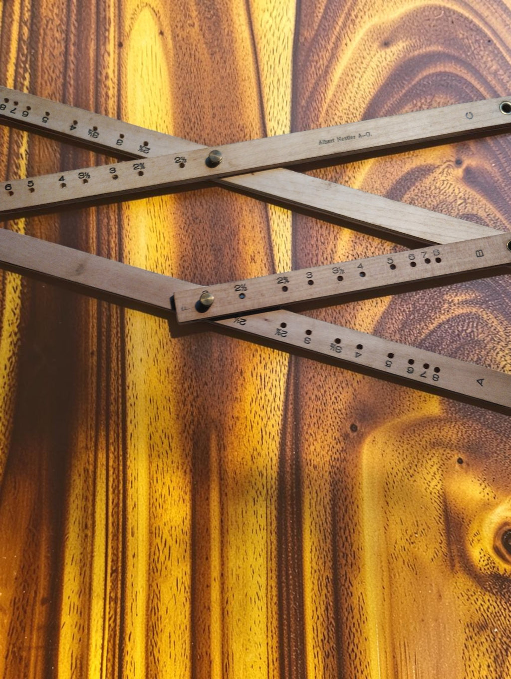 Detail of the Nestler No. 248 pantograph showing wooden arms, scale markings, adjustment holes and pivot screws.
