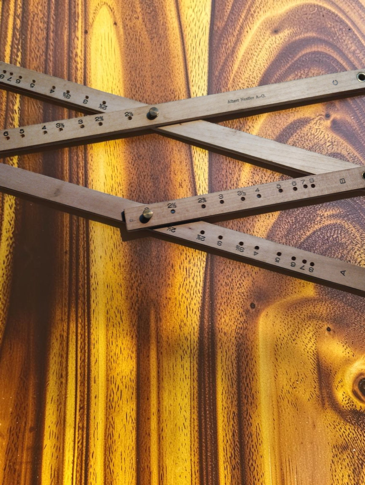 Detail of the Nestler No. 248 pantograph showing wooden arms, scale markings, adjustment holes and pivot screws.
