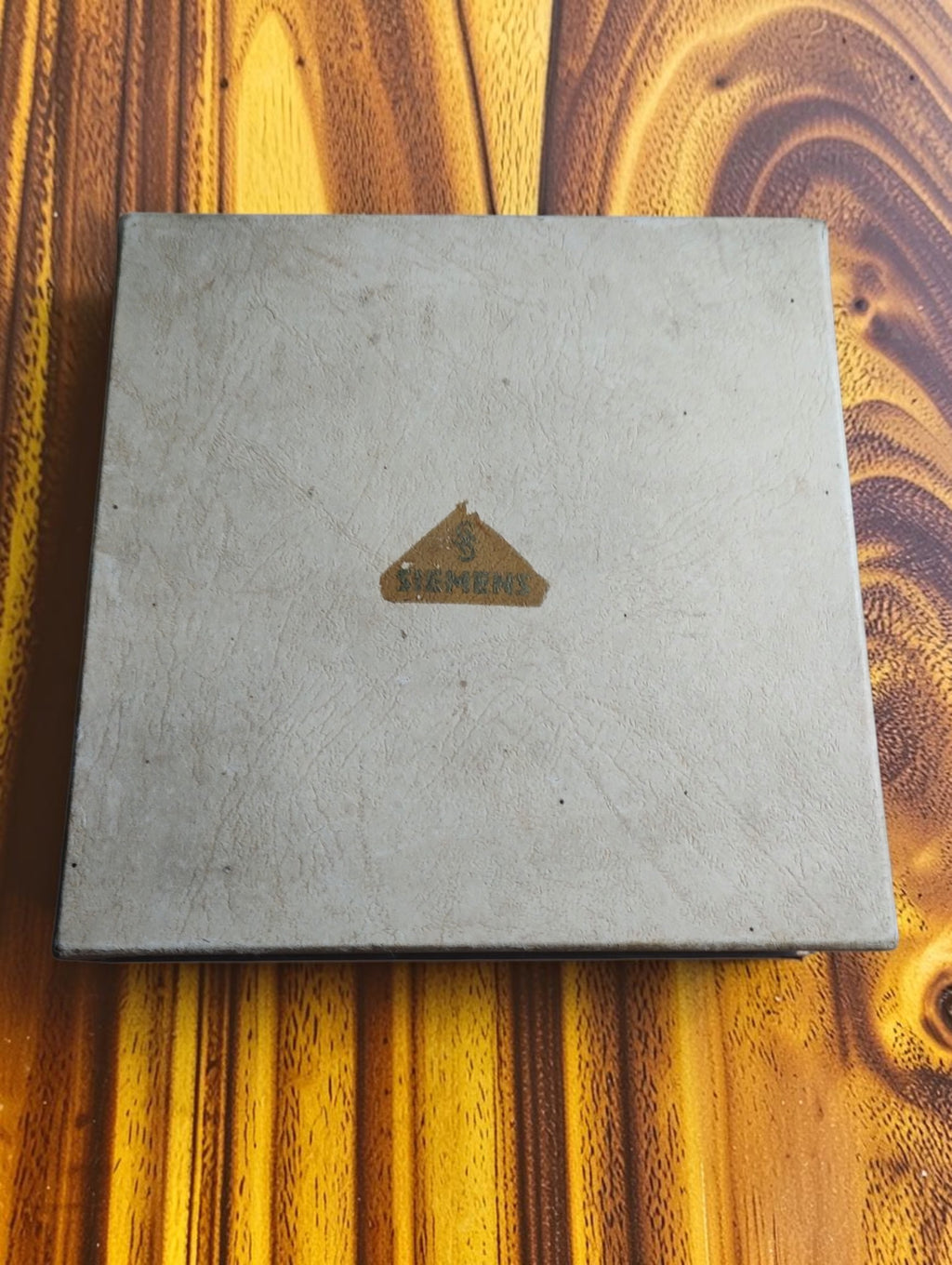 Closed storage box for the vintage Siemens probe set, with a worn triangular Siemens paper label on the lid.

