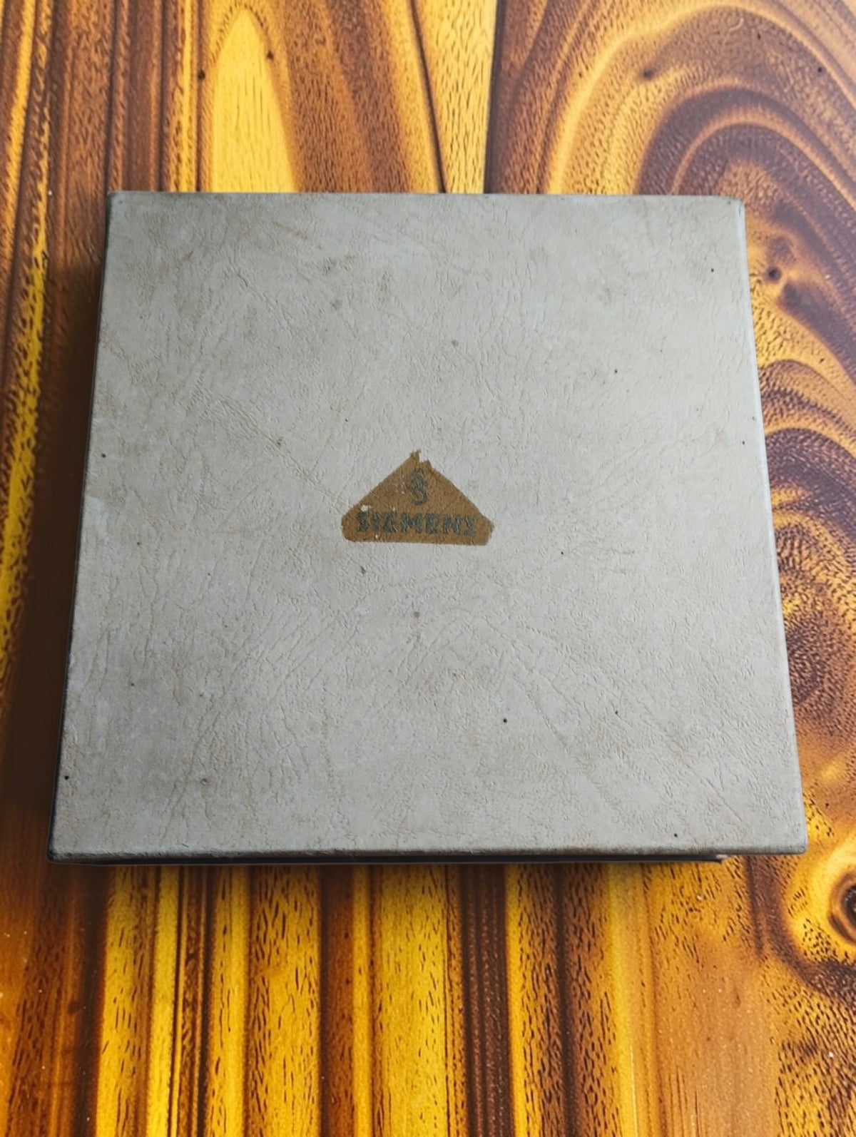 Closed storage box for the vintage Siemens probe set, with a worn triangular Siemens paper label on the lid.
