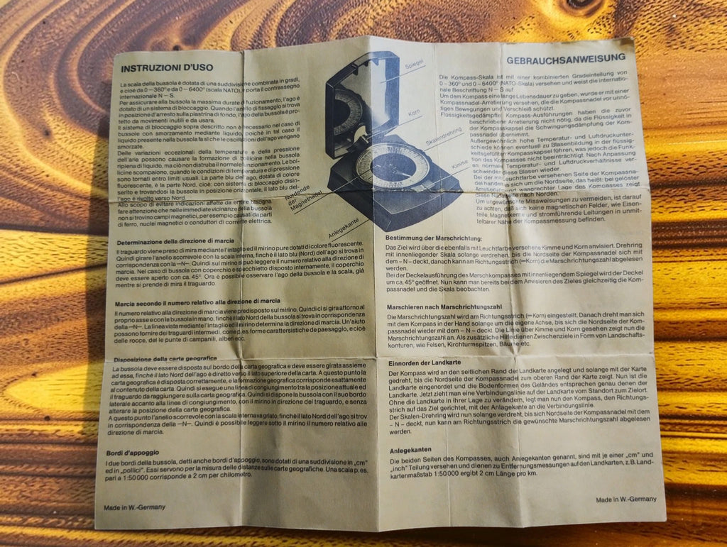 Original compass instruction sheet with German and Italian text and an illustrated compass diagram
