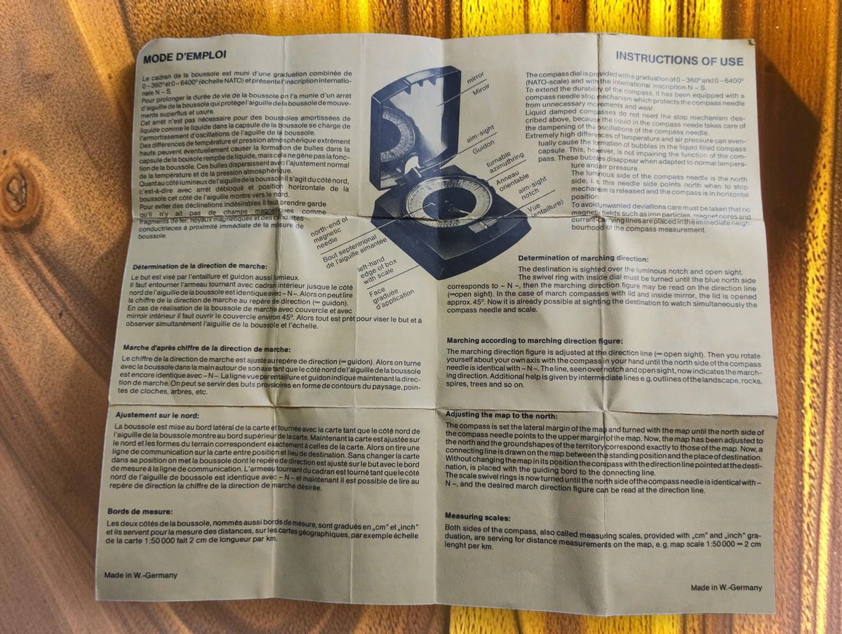 Original compass instruction sheet with French and English text and an illustrated compass diagram
