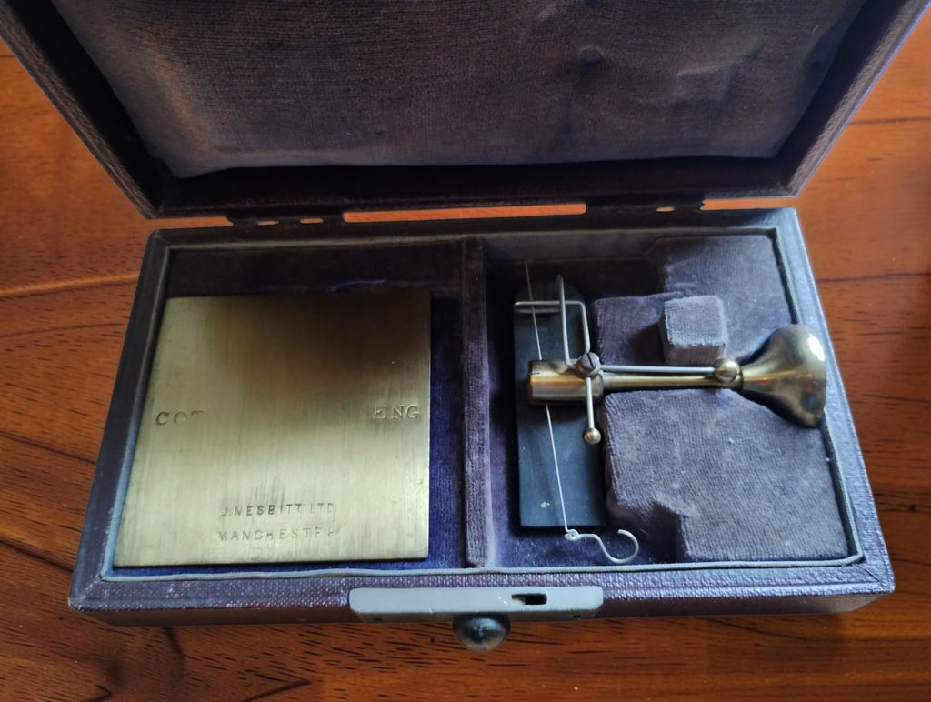 John Nesbitt yarn balance and brass measuring plates stored inside their fitted, fabric-lined case.
