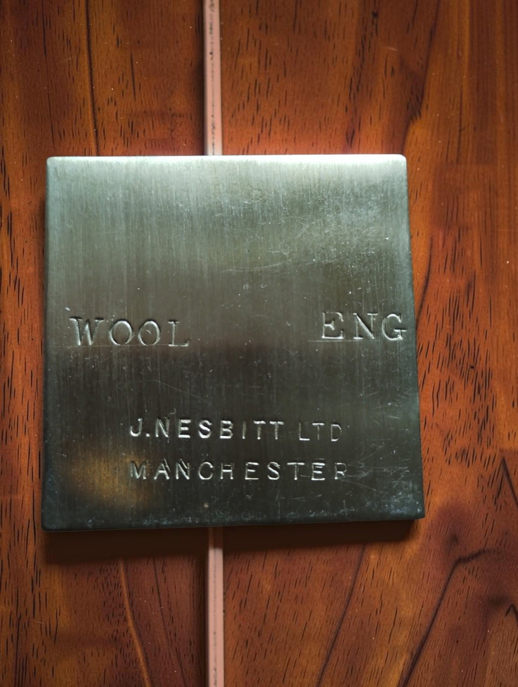 Brass WOOL plate stamped J. Nesbitt Ltd, Manchester, with the additional marking ENG.
