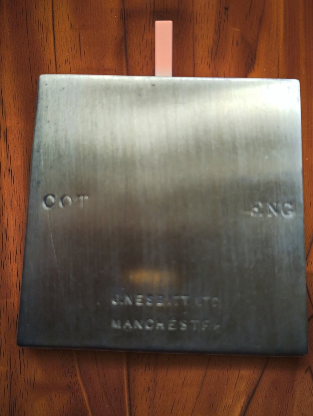 Brass COT cotton plate for the John Nesbitt yarn balance, with stamped Manchester maker markings.
