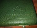 Close-up of the embossed DIXI gear logo and Le Locle Suisse lettering on the green watchmaking tool case
