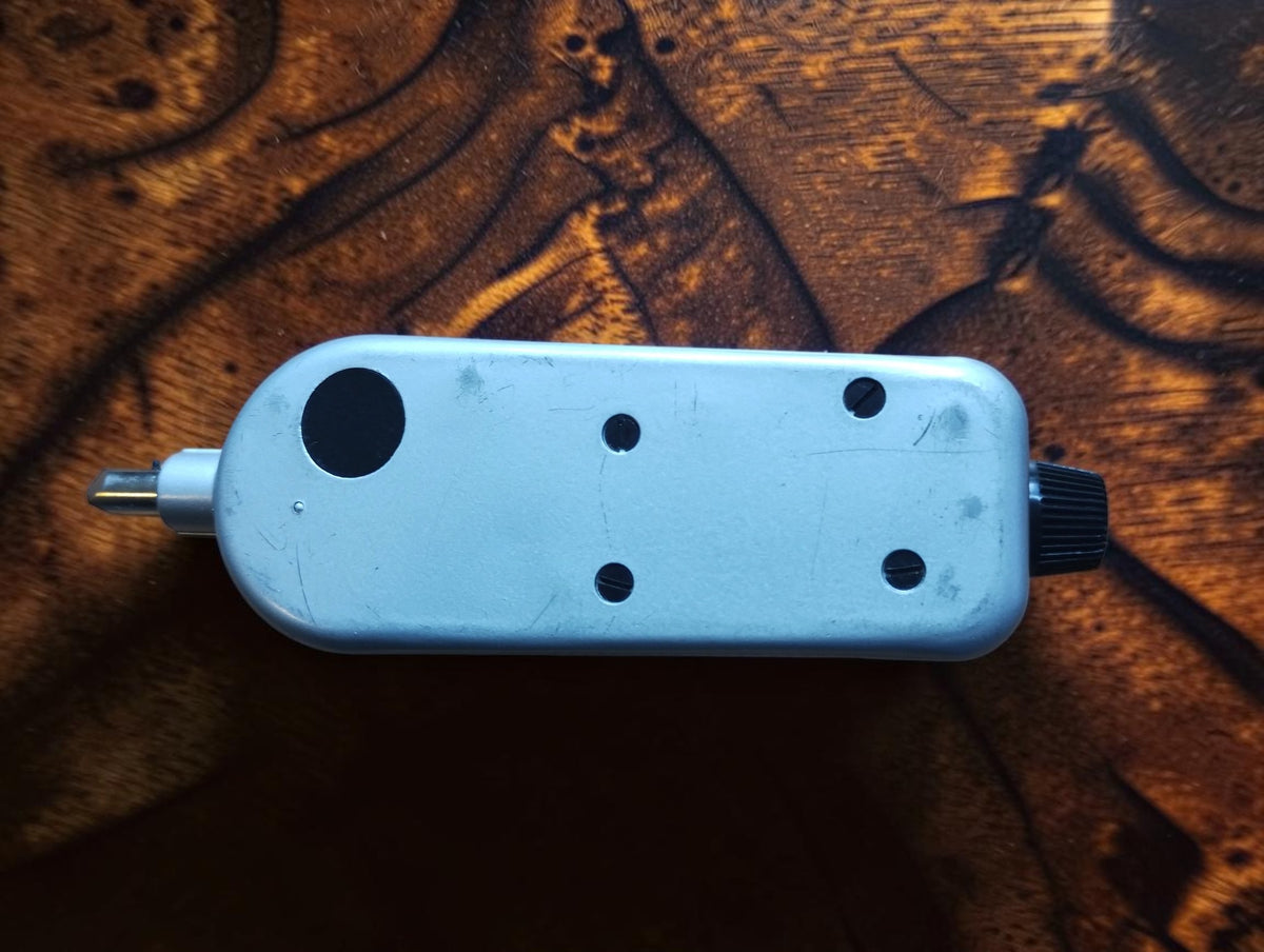 Rear view of the IVO Probator hand tachometer showing the metal housing, drive shaft and side knob
