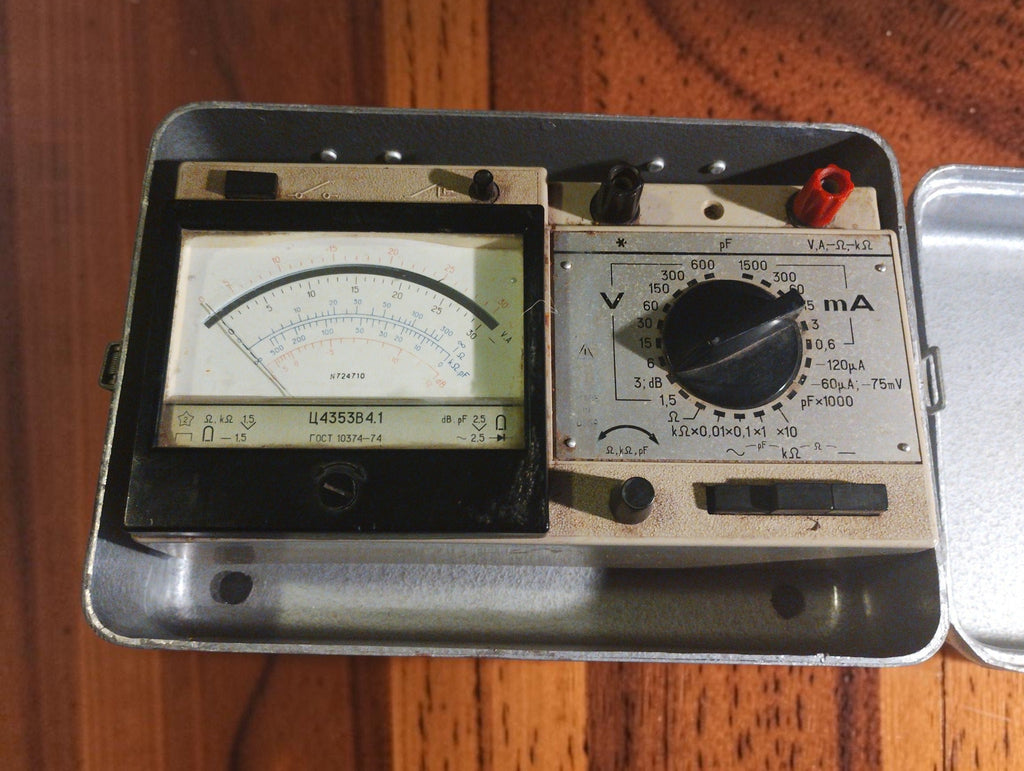 Ц4353 В4.1 analog multimeter in an open metal case, showing the needle display, range selector and connection terminals.
