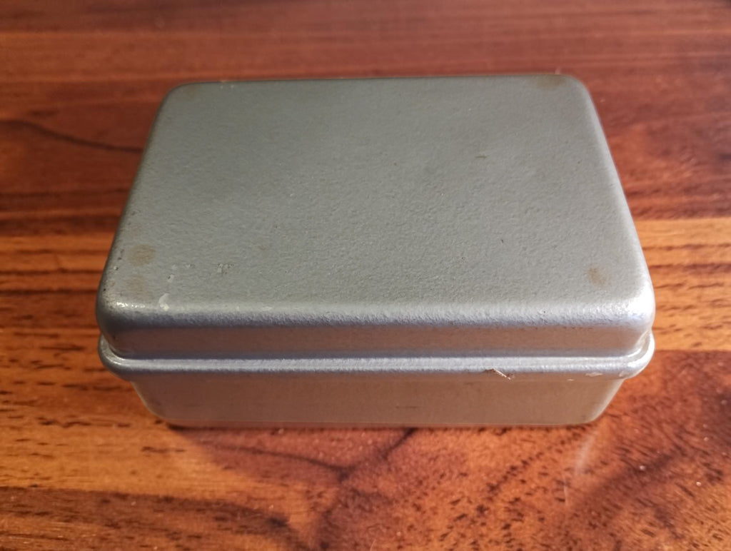 Closed metal protective case for the Ц4353 В4.1 analog multimeter, showing surface wear and signs of age.
