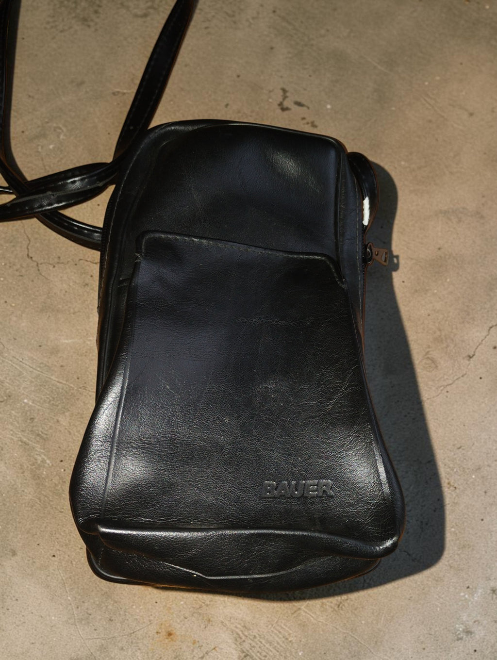 Original black Bauer camera carrying bag with shoulder strap and front pocket
