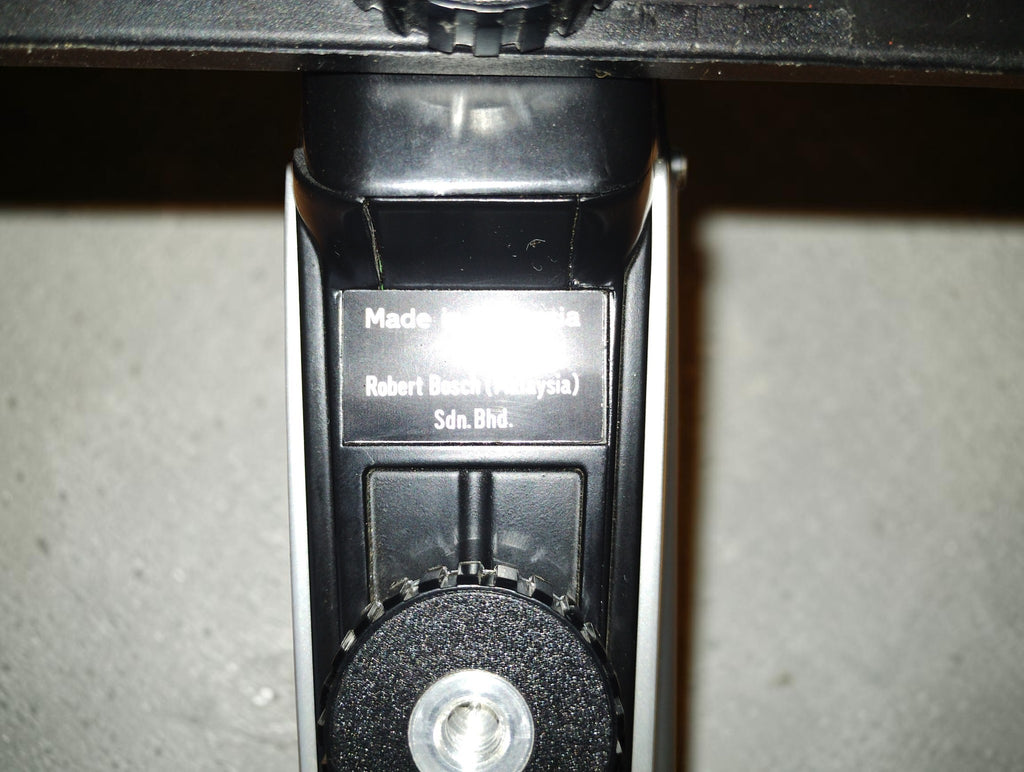 Underside of the Bauer C8 makro movie camera showing the manufacturer plate and tripod mounting socket
