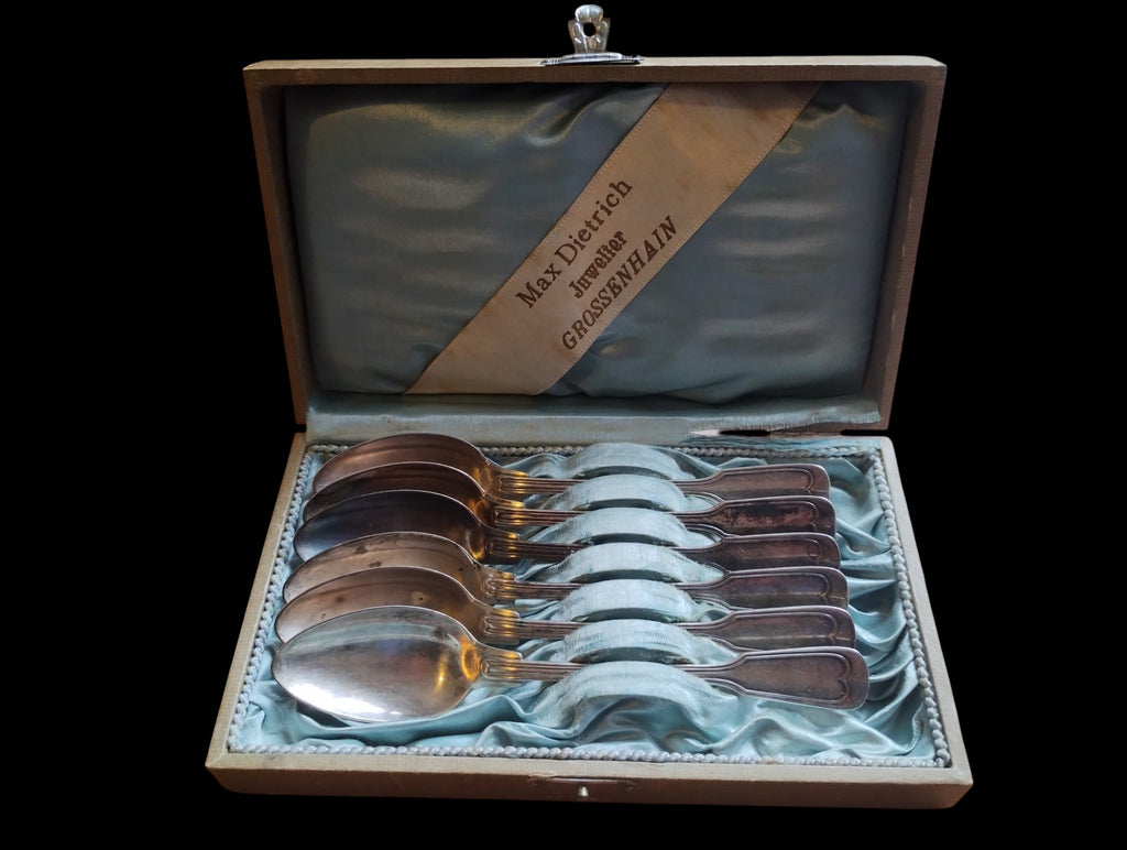 Vintage spoon set in a pale blue lined case with a Max Dietrich jeweler's ribbon inside the lid
