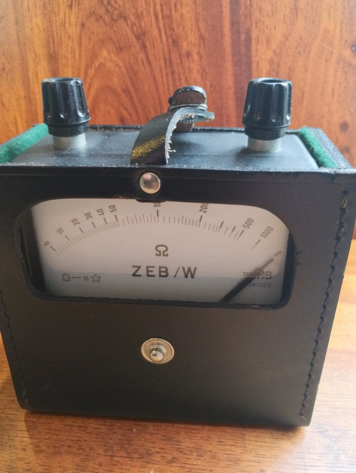 Hartmann & Braun ZEB/W vintage ohmmeter in its open black leather case, showing the analog resistance scale and two top terminals.
