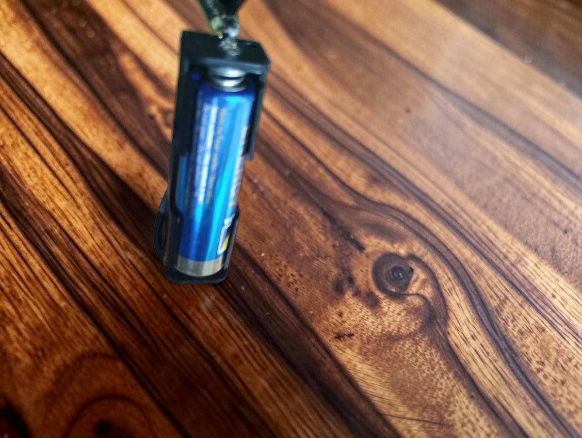 Close-up of the modified external battery holder with an AA battery for the ELIMA Elavi 1 multimeter
