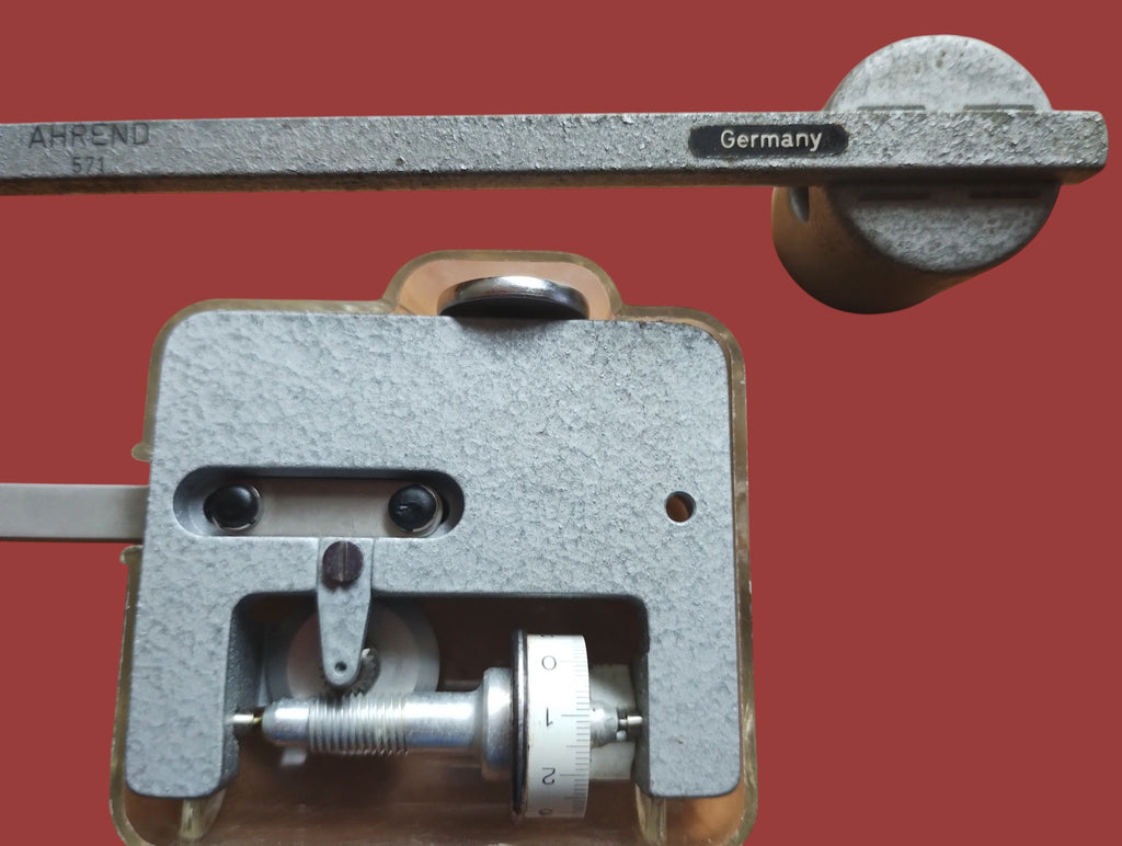 Close-up of the A. Ott polar planimeter measuring wheel, graduated dial and metal mechanism
