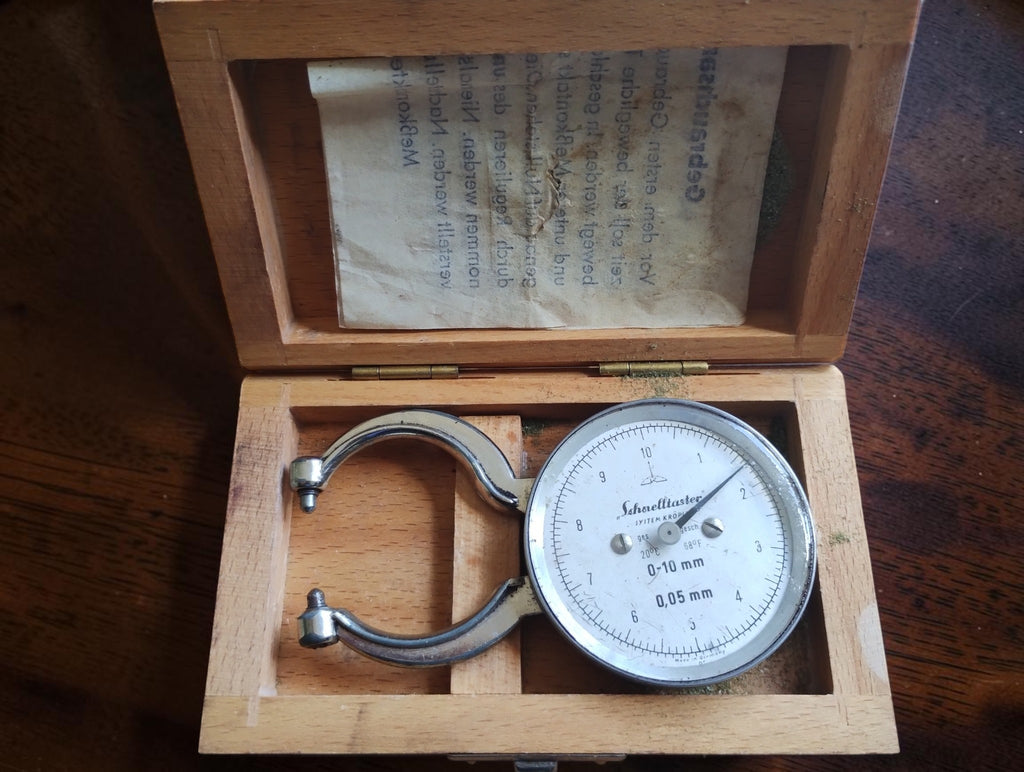 Kroplin Schnelltaster dial thickness gauge in its open wooden case, with German instructions inside the lid.
