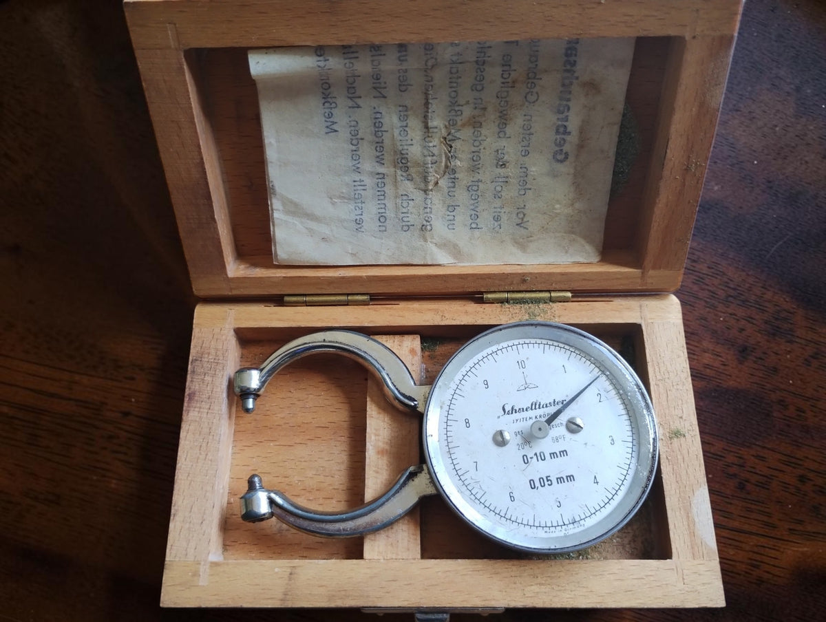 Kroplin Schnelltaster dial thickness gauge in its open wooden case, with German instructions inside the lid.
