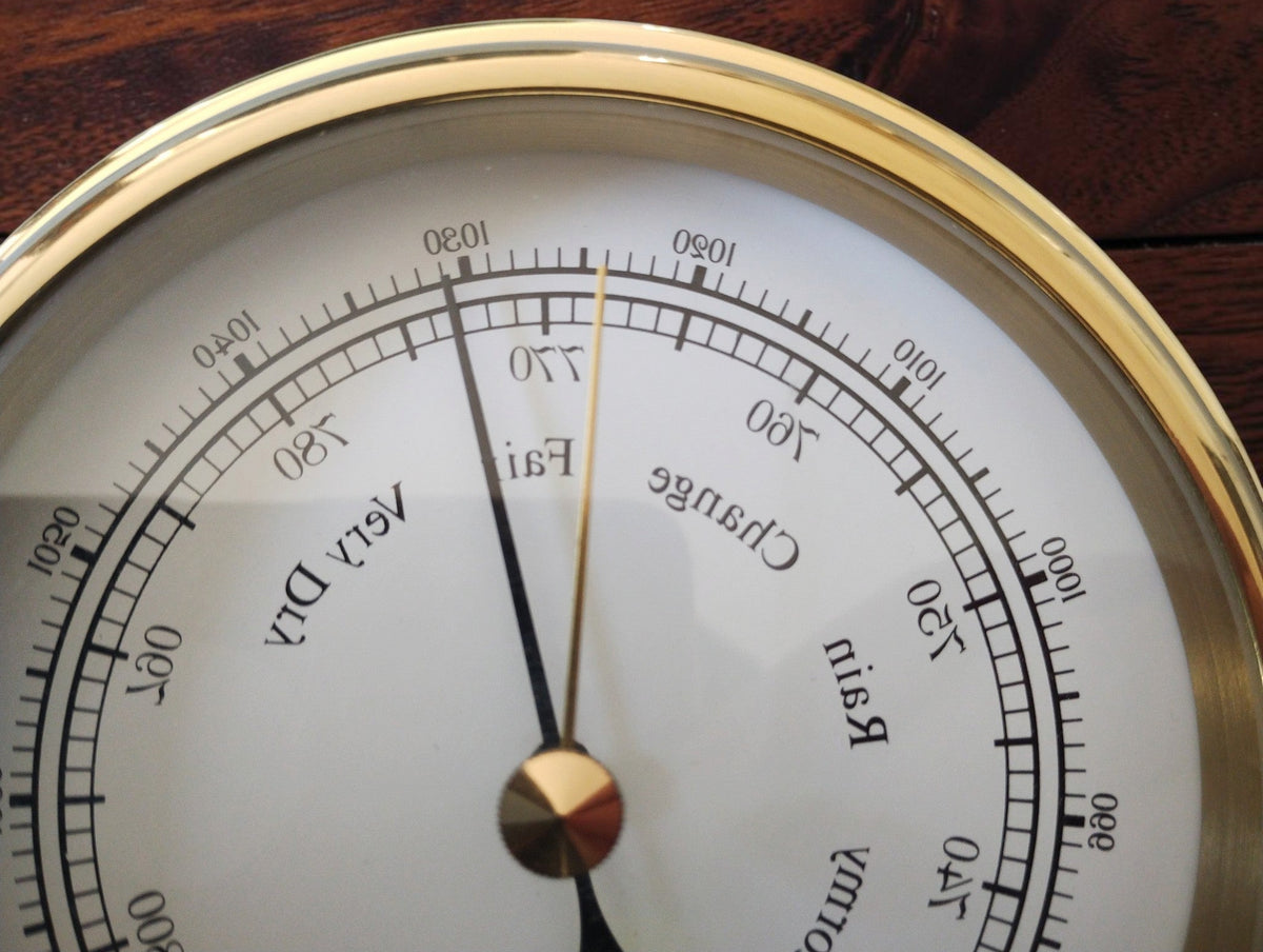 Close-up of the BARIGO barometer's black pointer, gold-tone reference pointer and English weather markings.
